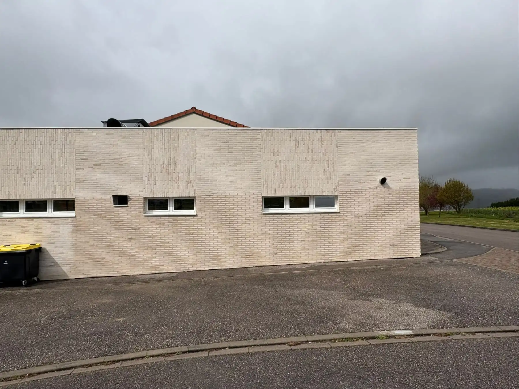 Façade d’un bâtiment habillée de plaquettes de parement claires, réalisée par BMB Construction